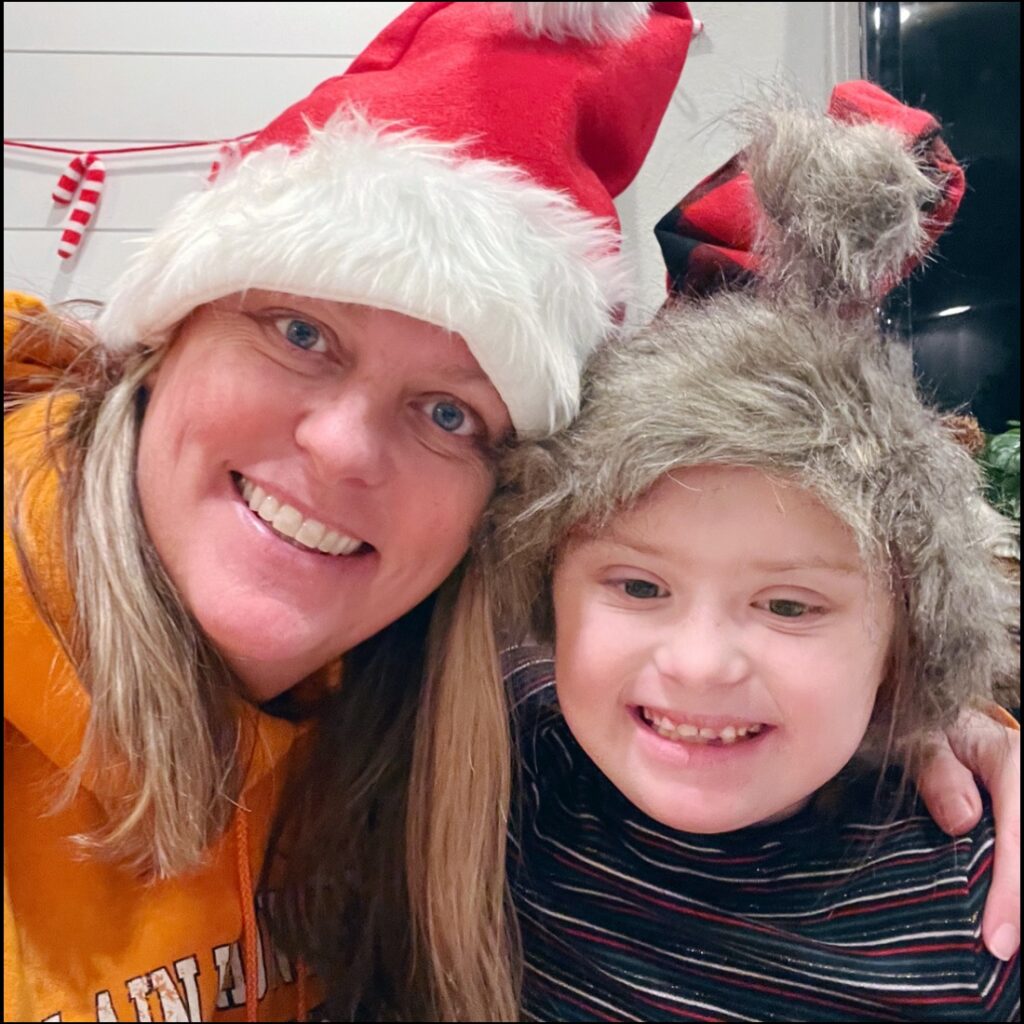Megan Mitchell and Charlie with Santa hats for Santa Claus day