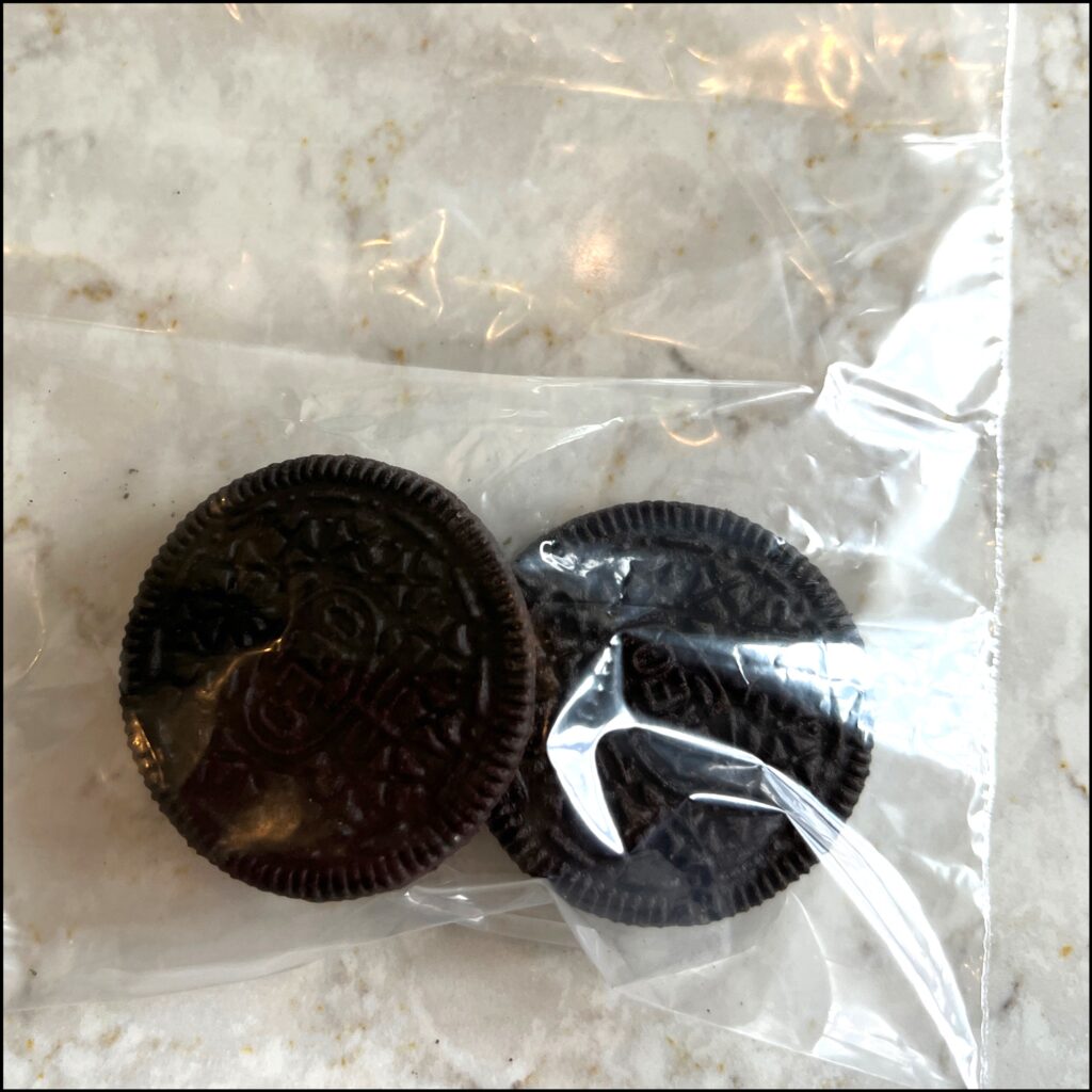 crush Oreo cookies in a plastic bag